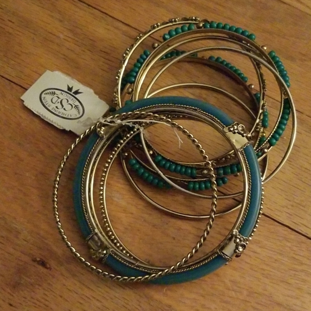 Green and gold tone bracelets